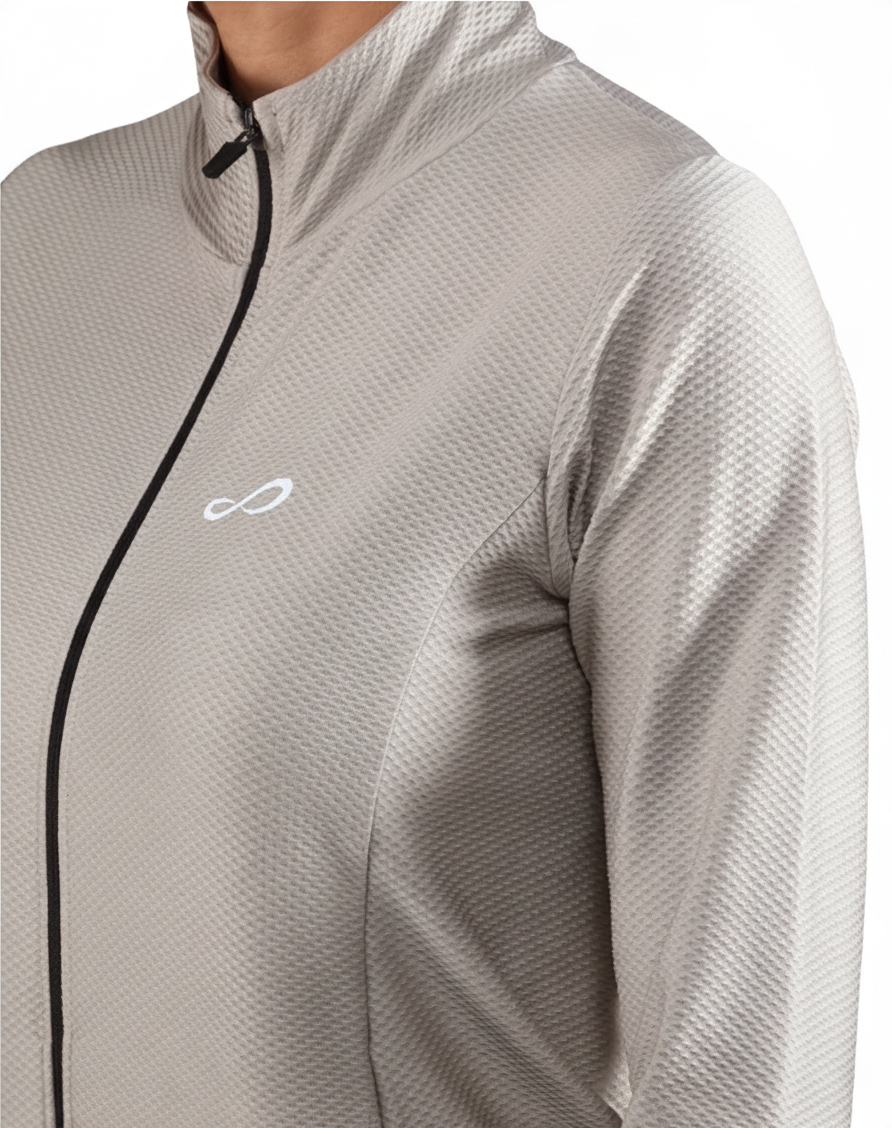 Chaqueta deportiva Endless MX Lithe de color gris con cremallera, cuello alto y tejido técnico transpirable.