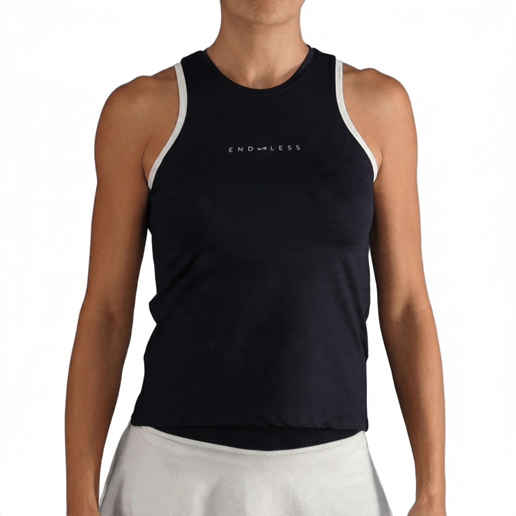 Top deportivo Endless MX negro con cuello cerrado y detalles en contraste blanco para tenis y pádel.