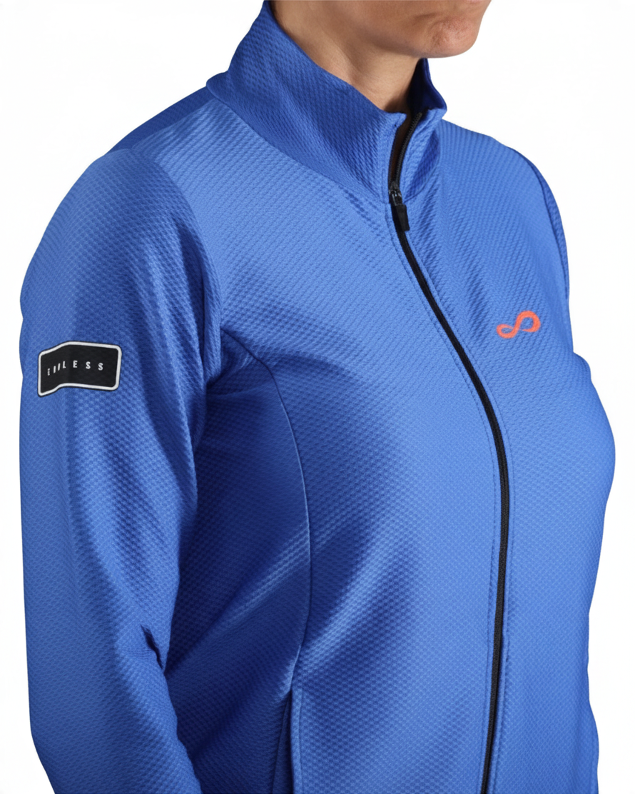 Chaqueta deportiva Endless MX azul de mujer con cremallera, cuello alto y tejido elástico transpirable.